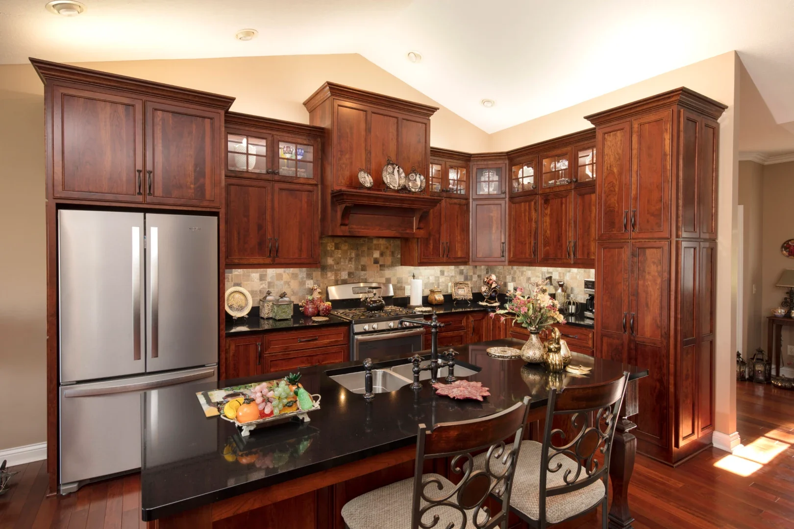 Full cherry kitchen with a large island and custom storage