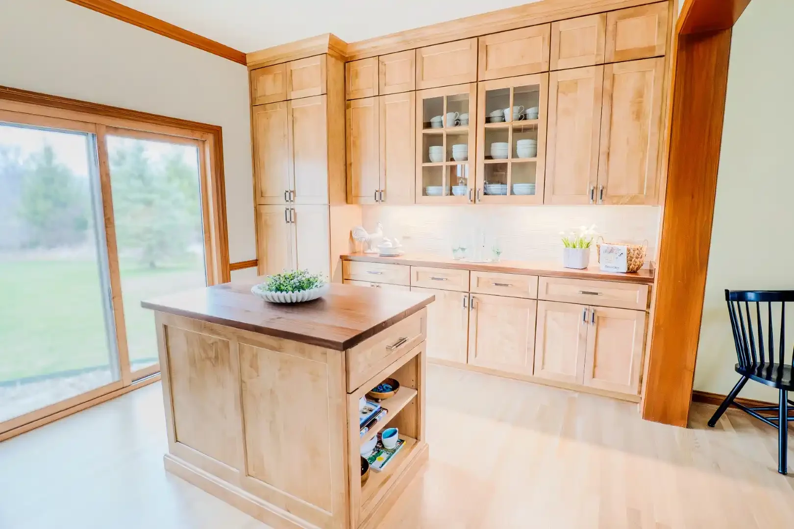 Custom Amish-built kitchen cabinetry in natural hardwood with a large island