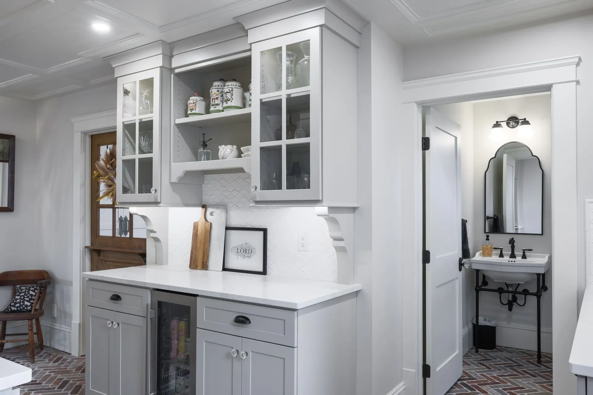 Custom butler pantry and beverage bar with glass-front upper cabinets