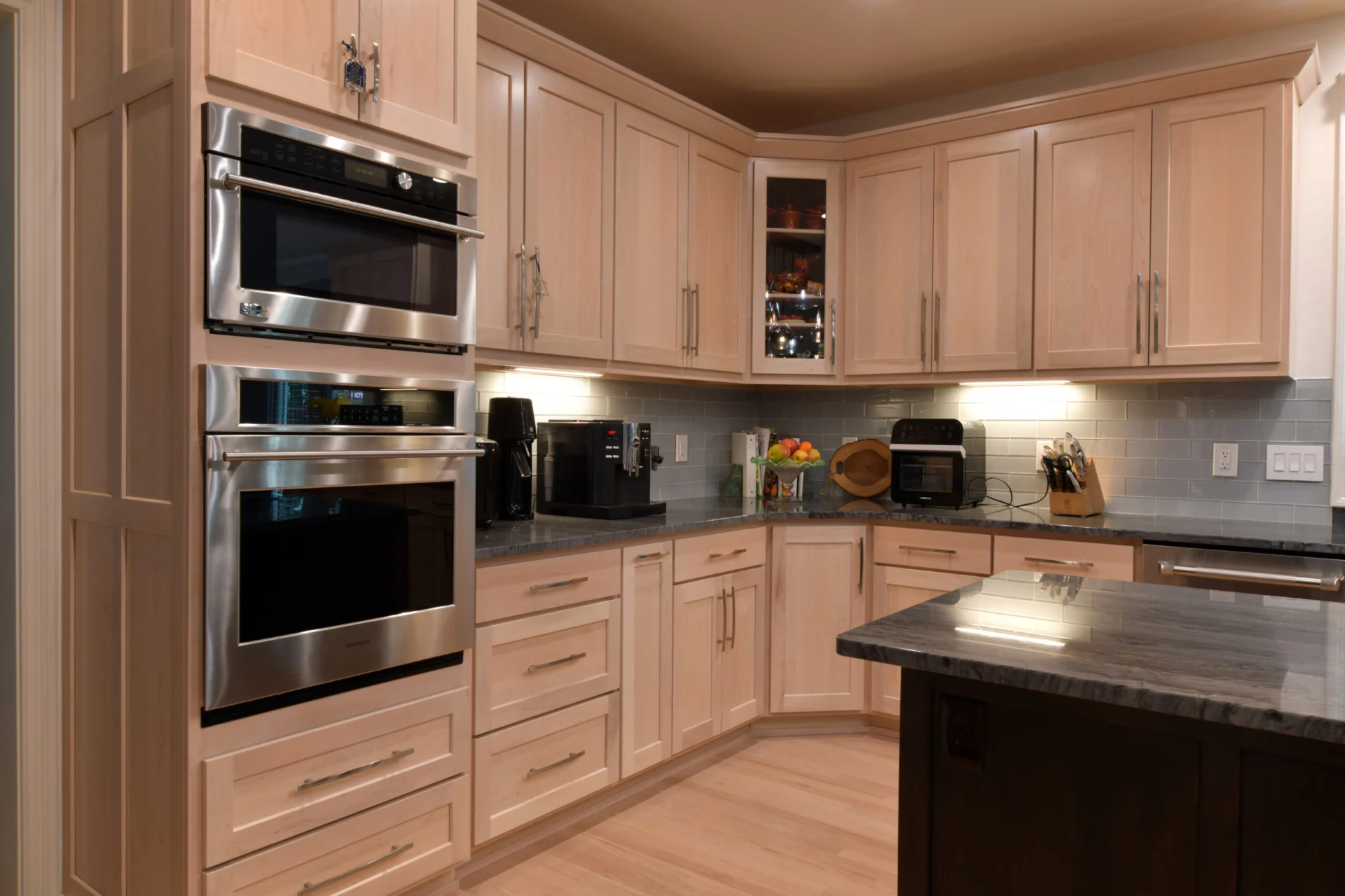 Finished kitchen pairing painted cabinetry with natural hardwood